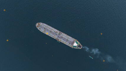 Aerial view oil ship tanker vessel loading and unloading in oil terminal station refinery, Global...