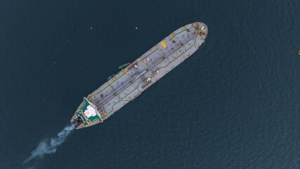 Aerial view oil ship tanker vessel loading and unloading in oil terminal station refinery, Global...