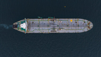 Aerial view oil ship tanker vessel loading and unloading in oil terminal station refinery, Global...