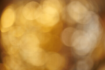 cream background with elegant gold bokeh particles