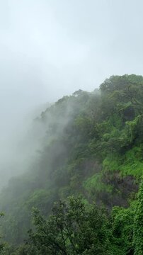 Beautiful landscape of hills during monsoon season at Matheran, Maharashtra,india. Lush green hills and dark clouds moving during rainy days.Travel and holidays concept