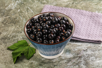 Ripe black currant in the bowl