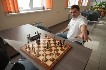 Caucasian man celebrates winning chess. 