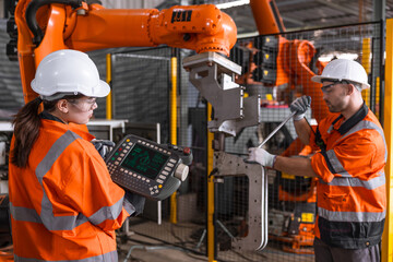 Technician engineer team fix service maintenance inspection robot arm installation in factory.
