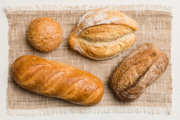 Assortment of freshly baked bread with napkin on rustic table top view. Healthy unleavened bread....