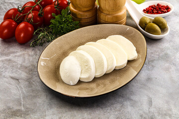 Organic mozzarella cheese slices in the plate