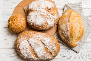 Assortment of freshly baked bread with napkin on rustic table top view. Healthy unleavened bread. French bread