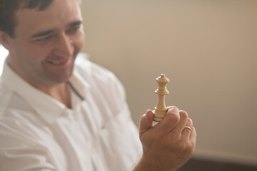 Middle aged Caucasian man playing chess. 