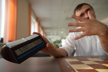 Middle aged Caucasian man playing chess. 