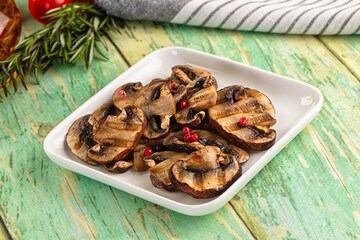 Tasty hot grilled champignon mushrooms