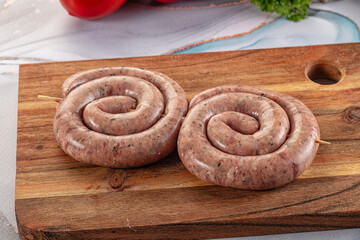 Raw meat pork and beef swirl sausages