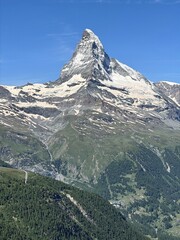 The Matterhorn peak in the Swiss Alps on a sunny day, Zermatt, Switzerland,  forest and snow...