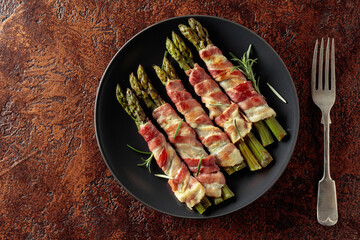 Grilled green asparagus wrapped in bacon.