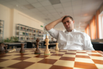 Middle aged Caucasian man playing chess. 