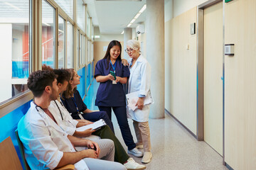 Medical team collaborating in hospital corridor, discussing patient care