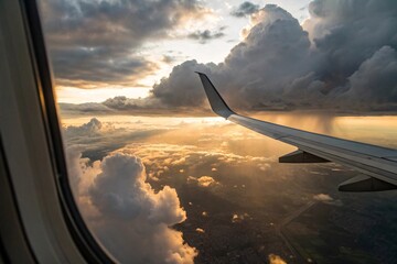 Naklejka premium Spectacular View of a Commercial Airliner Wing Against a Dramatic Sunset Sky with Sun Rays Breaking Through Clouds