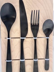 Black Cutlery Set Mounted on Wooden Board