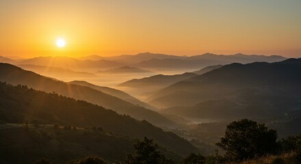 Obraz premium Sunrise over misty mountain valley