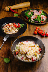 Three appetizing dishes are beautifully arranged on a rustic wooden table