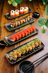 Artfully arranged sushi rolls on wooden table in Japanese restaurant setting