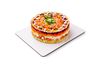 Colorful layered salmon cake with fresh vegetables on a white plate