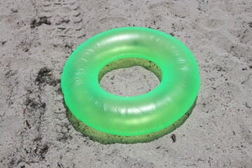 green inflate donut on the sand