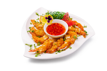 Delicious crispy shrimp served with spicy dipping sauce on white plate