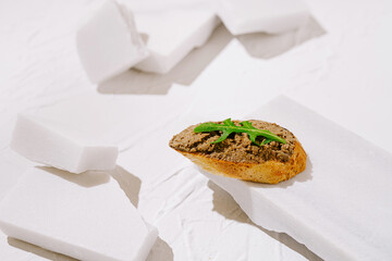 Unique appetizer presentation featuring bread and spread on a simple backdrop