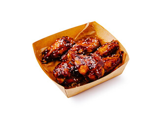 Crispy chicken wings with sweet glaze served in a takeaway box