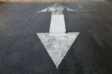 Two sides triangle arrow sign on the road asphalt