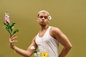 Captivating young man exudes style with flowers in vibrant studio setting