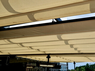 rolling pergola with pleated tarpaulin. can be extended in rails and shade the glass roof above the...