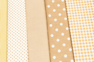 Mix of beige, white and brown cotton fabric.
