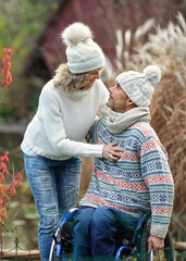 Autumn Embrace: A Man in a Wheelchair and His Girlfriend Enjoying Life in the Garden