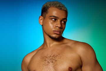Muscular young man with dyed hair poses confidently in vibrant studio setting