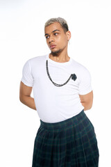 Young man in stylish outfit showcasing modern fashion in studio setting