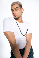 Young african american man showcasing bold fashion in modern studio setup