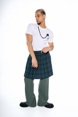 Stylish young African American man with dyed hair poses confidently in a studio