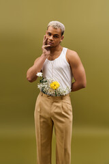 Expressive young man with dyed hair showcases style in floral arrangement