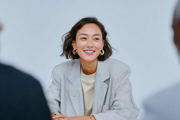 Young manager smiling during business meeting in office
