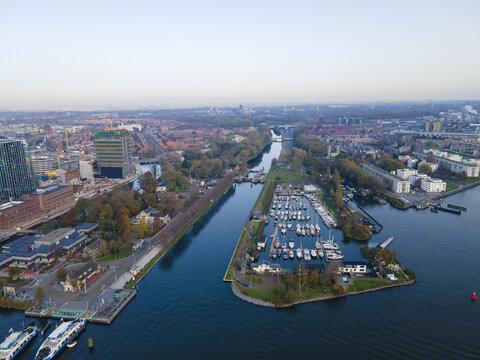 Aerial view of boats docked near the Oranje-Nassau barracks and the Singelgracht canal, with the city's architecture in the background, Amsterdam, North Holland, Netherlands.