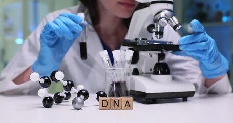 A scientist examines DNA strands under a microscope, revealing intricate molecular structures in a lab - Powered by Adobe