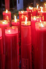 Giant red candles glow brightly in a temple during Chinese New Year and Cap Go Meh celebrations,...