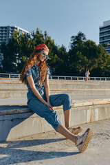 Lifestyle woman in modern boho-western denim street style with red bandana and sunglasses, casual...
