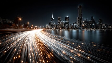 Optical fiber cables glowing against a city nightscape background illustrating internet speed and data networks