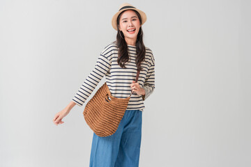 Relaxed Asian female adult in casual travel outfit showing positive cheerful attitude with good...