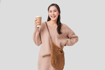 smart casual relax working asian female woman in sweater hand hold coffee cup portrait studio shot...