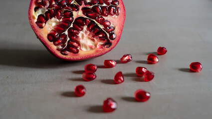 A half of a pomegranate with its seeds is on a table