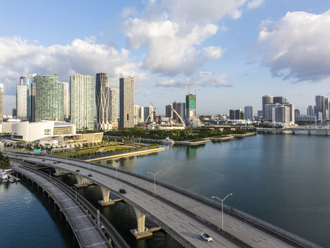 Aerial view of the Venetian Causeway leading to the vibrant skyline of Miami, with the Perez Art Museum standing out against the bright sky, Miami, Florida, United States.