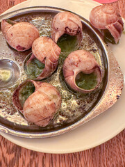 French Escargot Snails Served with Garlic Butter Sauce in Metal Plate